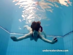 Redheaded Mia stripping underwater