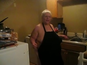 in the kitchen with apron on teasing 