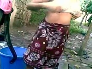 Indian village girl is changing her clothes outdoor