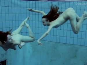 Nice ass lesbian with natural boobs performing her teases underwater