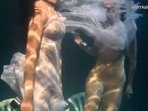 Natural boobs European lesbian swimming with her babe underwater