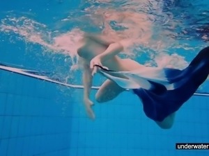 Teen girl Avenna is swimming in the pool