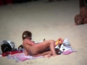 Two busty milfs expose their wonderful bodies on the beach